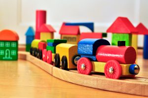 Colroful toy train going through a brick town